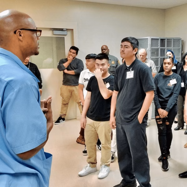 Anthony "Ant" speaks to a group of young people in a room at San Quentin State Prison.