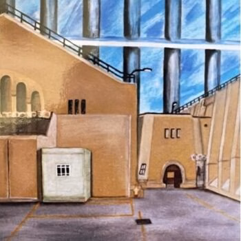 Two people stand in a large industrial courtyard with tan buildings and massive blue smokestacks under a bright sky.
