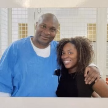 Gregory and a woman smiling together in a medical setting.