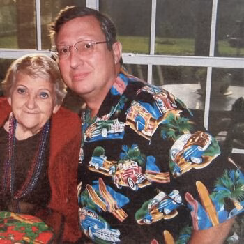 Aharon's (5) A man and an older woman posing together indoors.