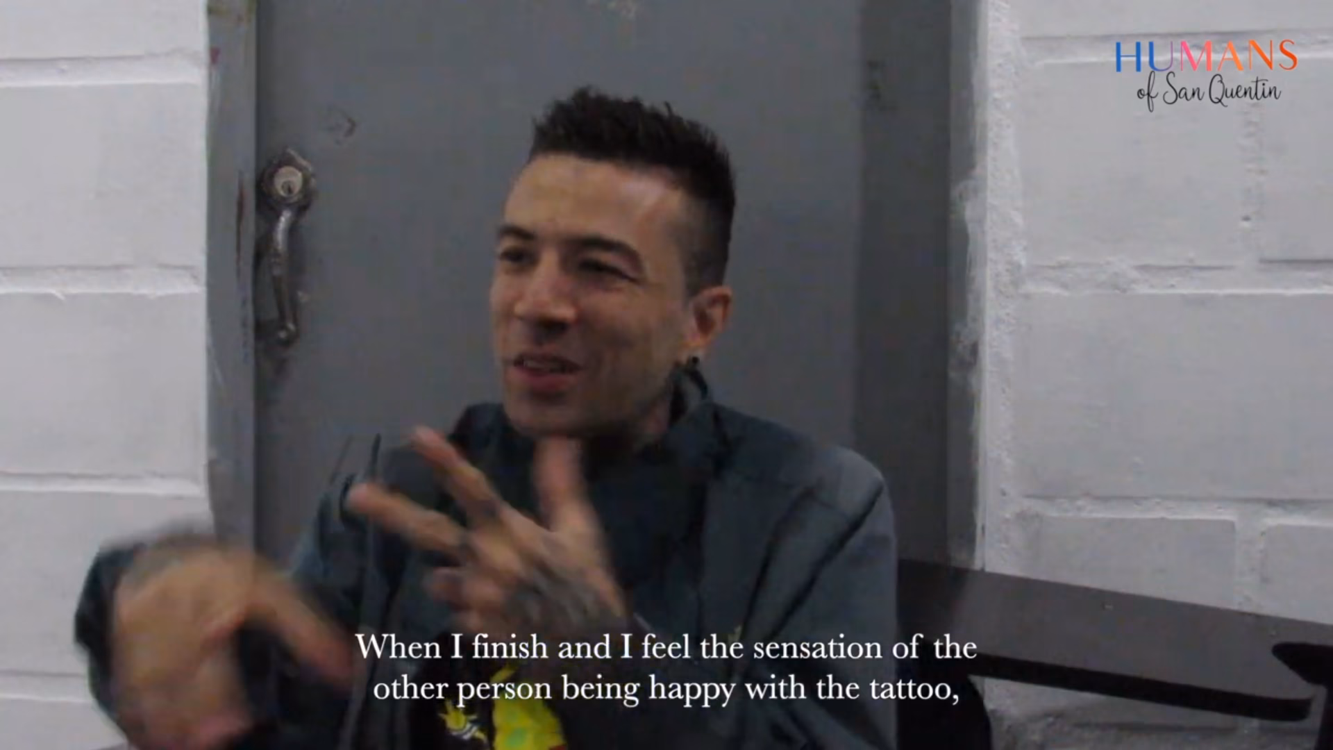 Mauricio, 34, speaks during an interview, gesturing with his tattooed hands.