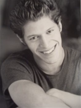 Paul 9 smiling in a black and white portrait.