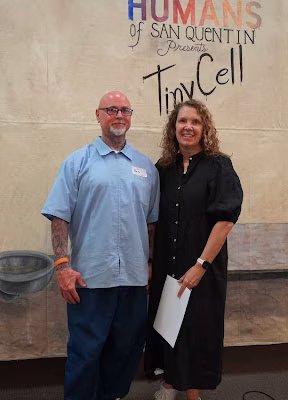 eric b 2 Eric B and a woman stand in front of a mural for the Humans of San Quentin Presents Tiny Cell event.