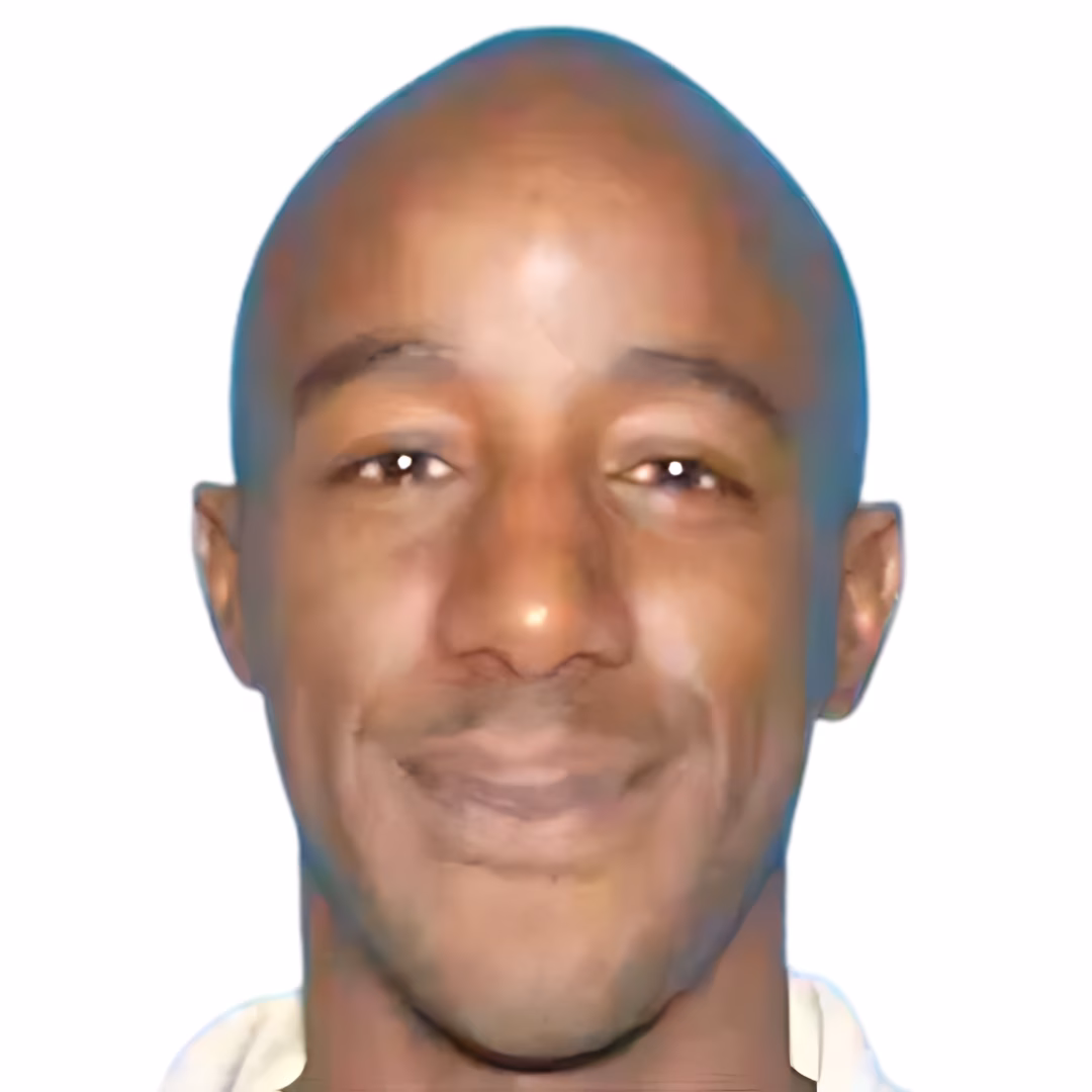 Portrait of Cornell, a bald man with a slight smile, against a plain white background.