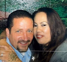 Shane Goddard and a woman posing together for a photo.