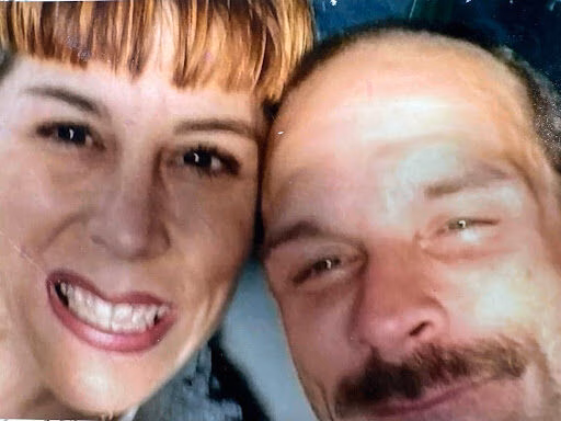 Close-up selfie of Marty Breedlove and a woman with their heads touching.