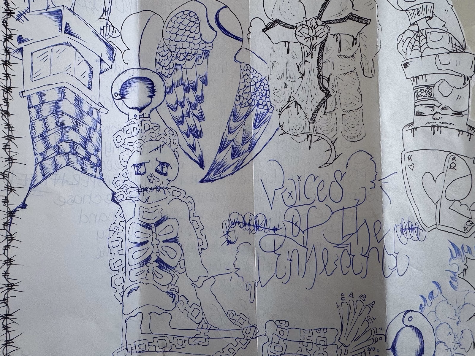 A blue ink drawing of a chained skeleton with a halo and wings, surrounded by various symbols including a tower, a heart, and playing cards, with the handwritten title 'Voices of the Enchanted'.