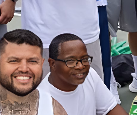 Chris and a man in glasses smiling together at an event.