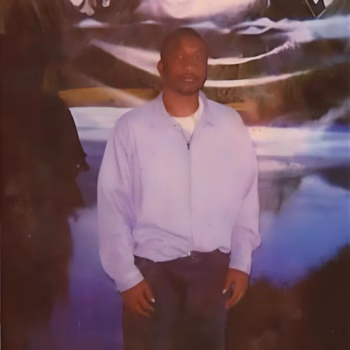 Victor, 45, stands in front of a mountain backdrop.
