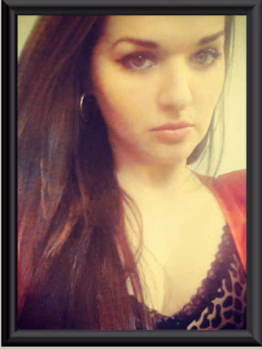Portrait of Heather, 31, with long dark hair and a red top.