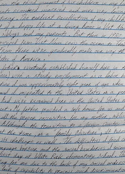 Handwritten text on lined paper detailing the life story of Tien, including her birth in 1950, her move to the US, and her education at White Oak Elementary School.
