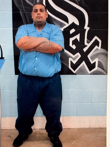 Jesse, a man with tattoos, stands with arms crossed in front of a wall featuring a large 'SEX' logo.