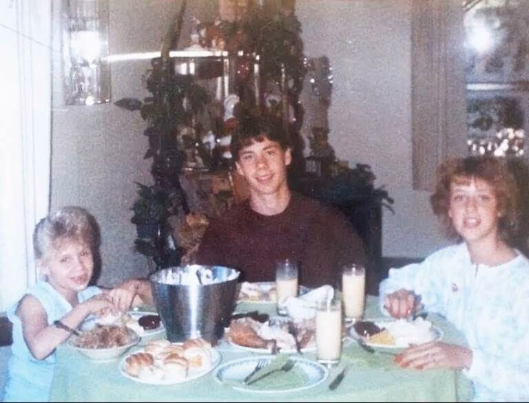 1290498596574330461 Jason, 53, and two young children eating a meal together at a dining table.