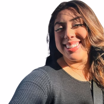 Klarissa, 27, smiling warmly with long brown hair and wearing a grey top.