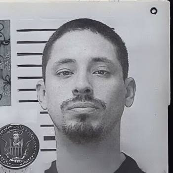 A black and white mugshot of a man with a goatee, identified as Tony, 38, against a height chart with the Great Seal of the United States in the corner.