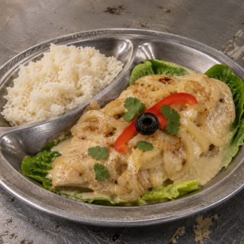 Idalio's Pollo Encremado (Creamy Chicken) recipe with white rice, creamy sautéed onions, romaine lettuce, cilantro, red bell pepper, and olive at San Quentin Rehabilitation Center.