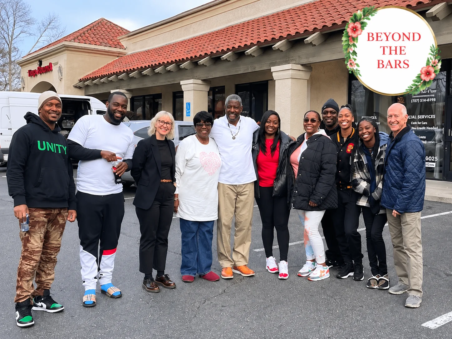 Darnell standing with the crew outside a building