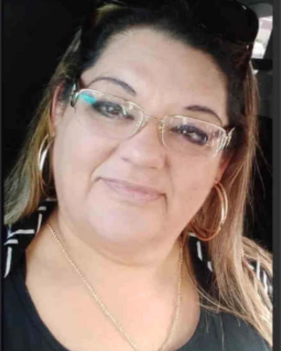 Portrait of Estefana wearing glasses and hoop earrings, sharing her personal story of incarceration, healing, and hope with Humans of San Quentin.